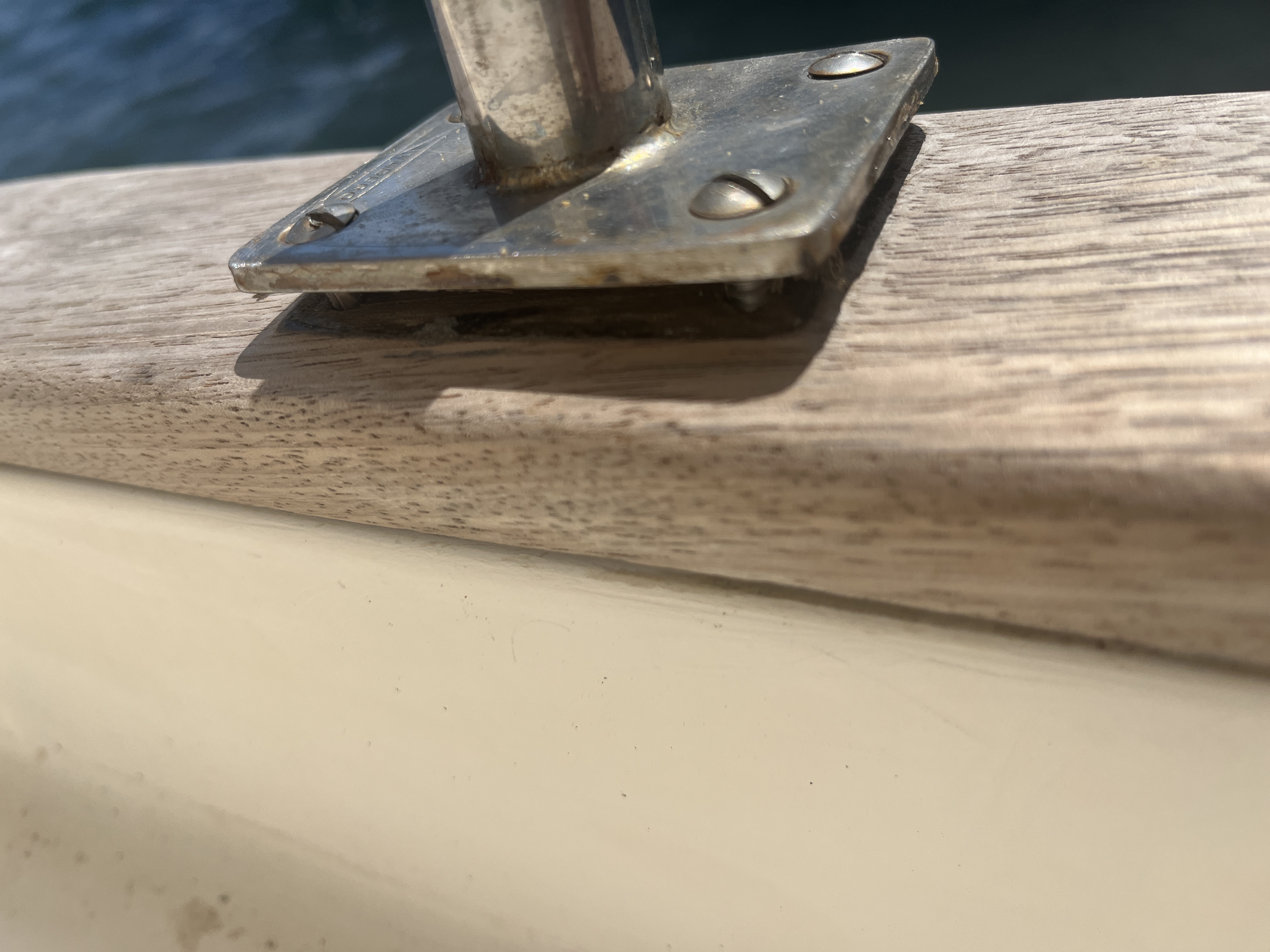Close-up of sun-faded timber and hardware before restoration.